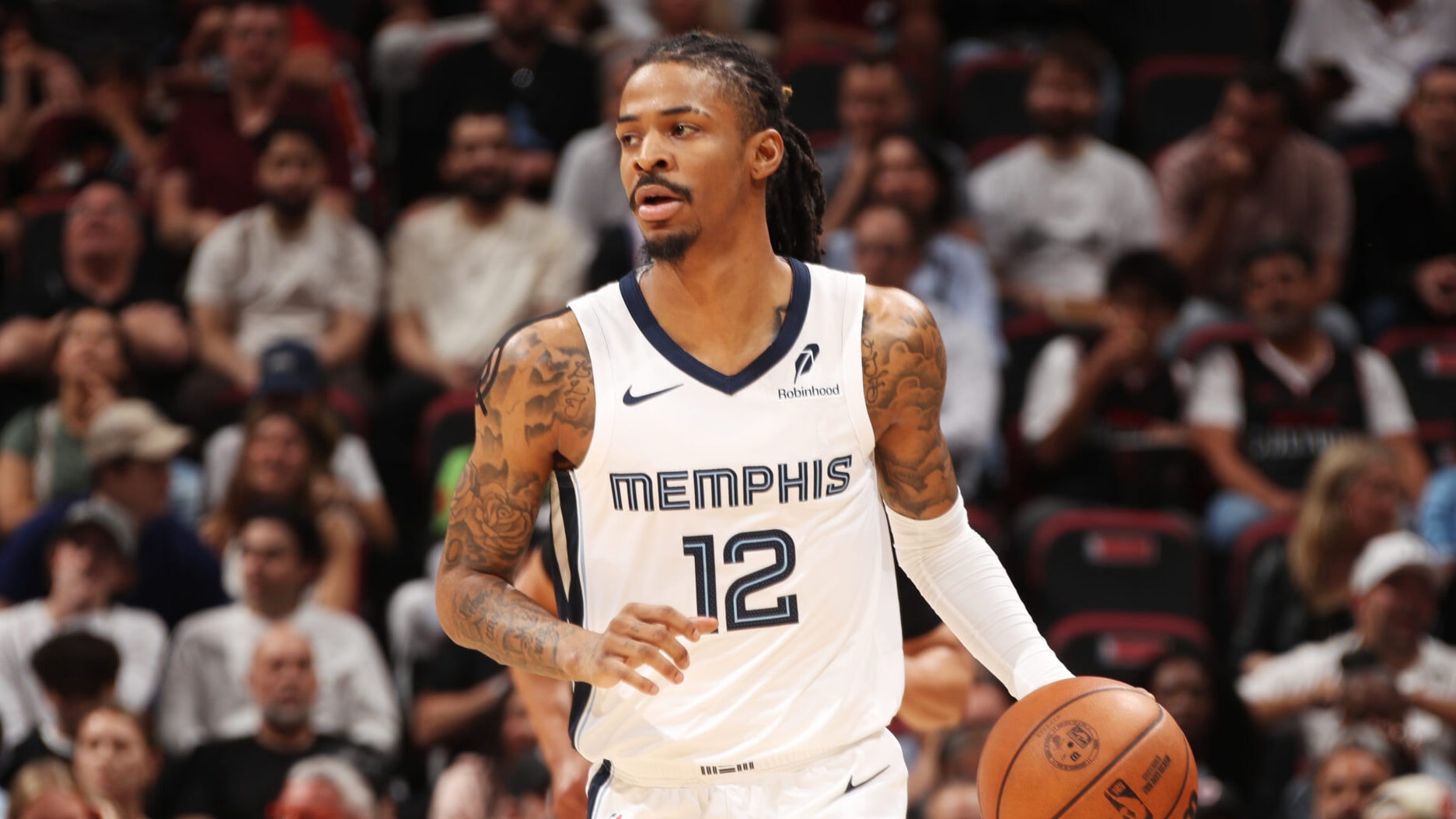 Ja Morant reacts in pain after suffering a hip injury during playoff game