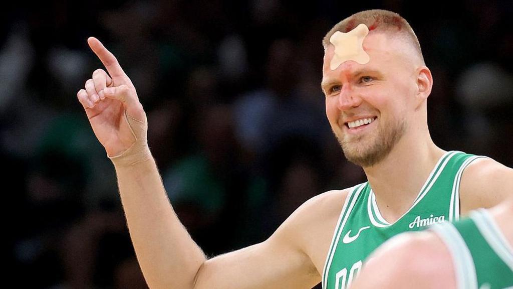 Kristaps Porziņģis returns to the court with a head bandage during the NBA playoffs