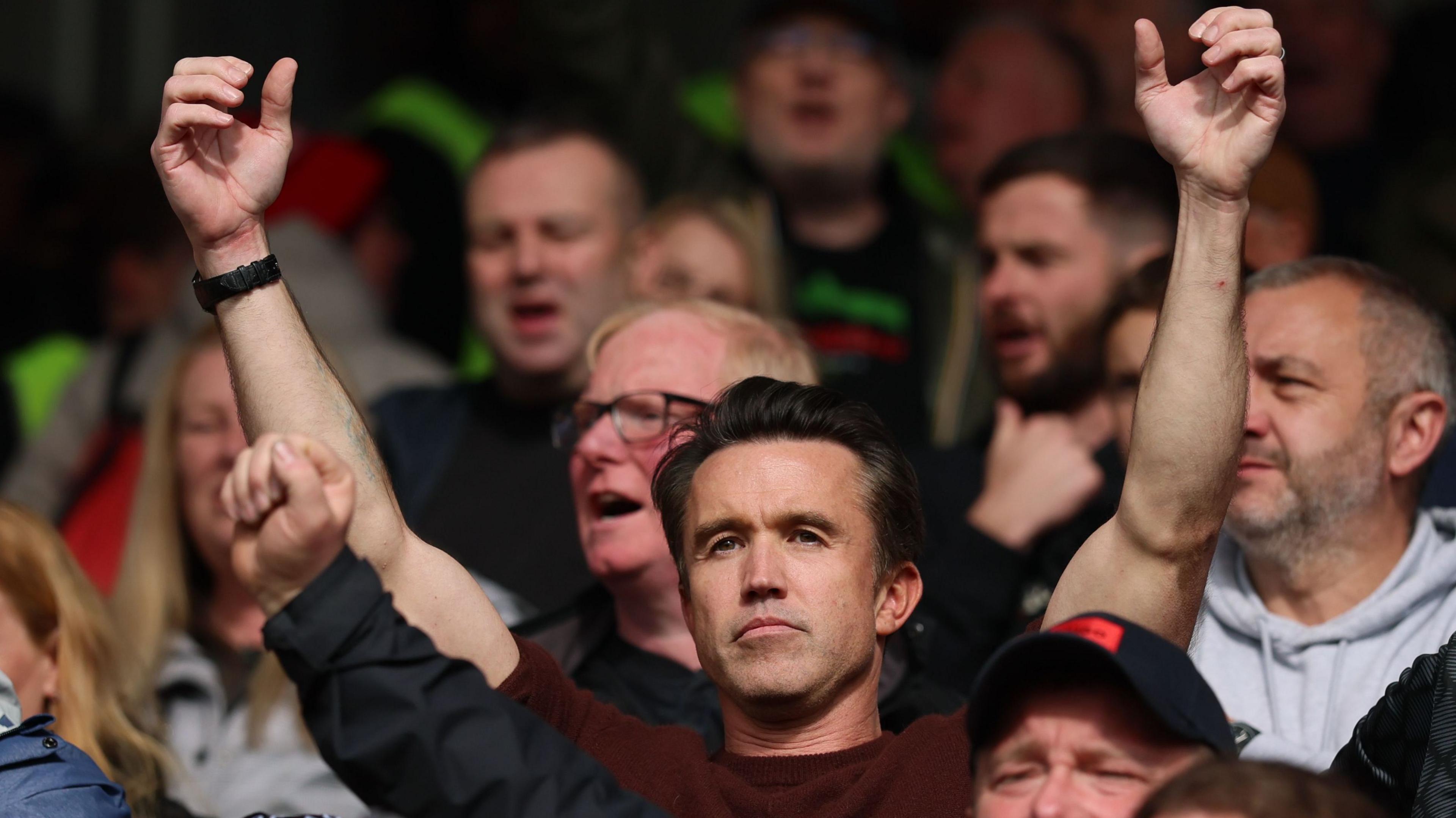 Wrexham's loyal fans in the stands, cheering for promotion glory