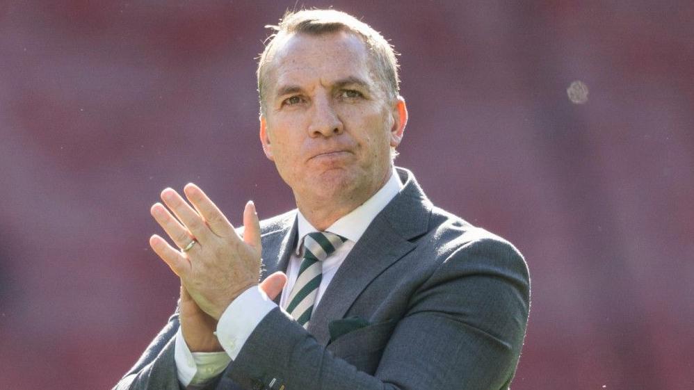 Brendan Rodgers celebrates with Celtic players after a trophy win