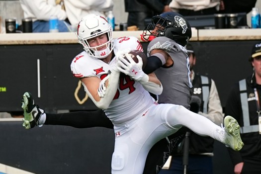 Jeremy Crawshaw in action punting during a college football game