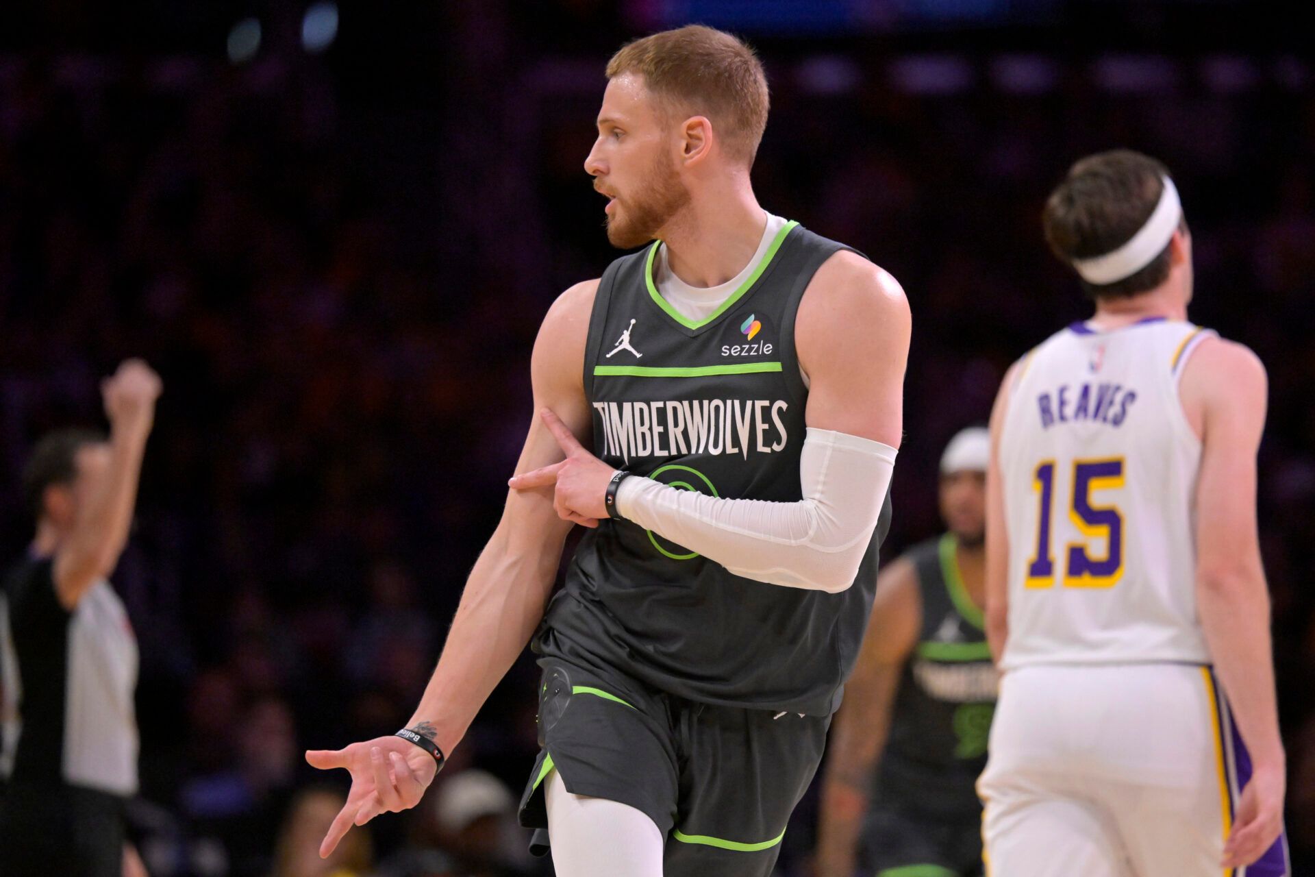 Donte DiVincenzo attacks the basket in a heated playoff game, showing intensity and focus.