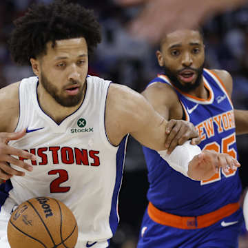 Detroit Pistons face off against the Knicks in Game 4, battling for each point. Pistons score narrowly trails Knicks. 