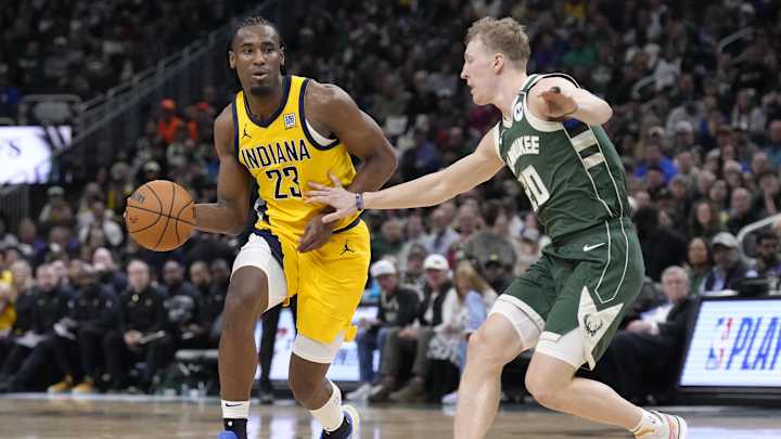 Aaron Nesmith driving against Bucks defender in NBA playoffs