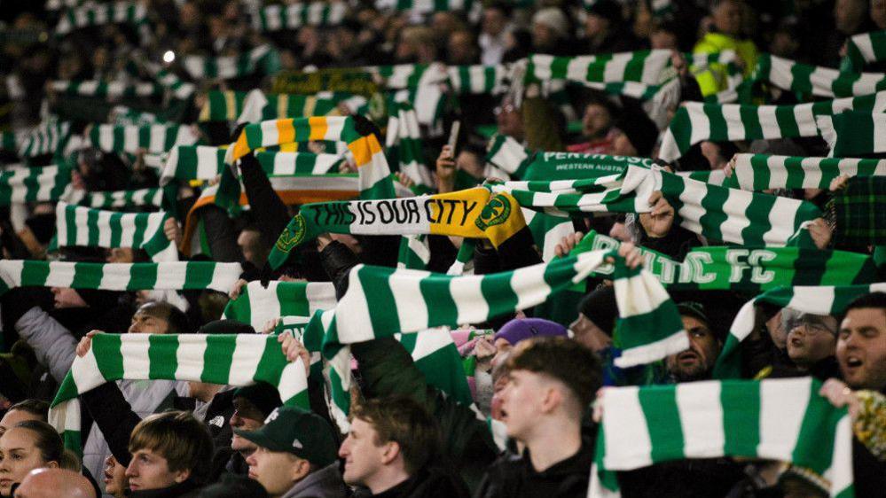 Celtic players celebrate winning the league title