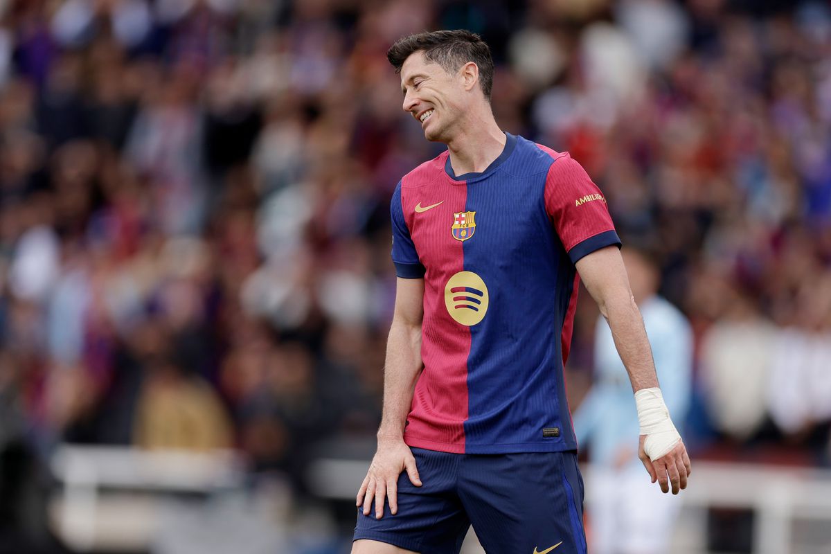 Robert Lewandowski receives medical attention following injury