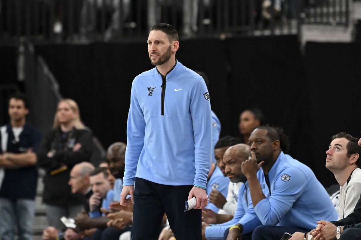 Villanova basketball coach addressing players during a game
