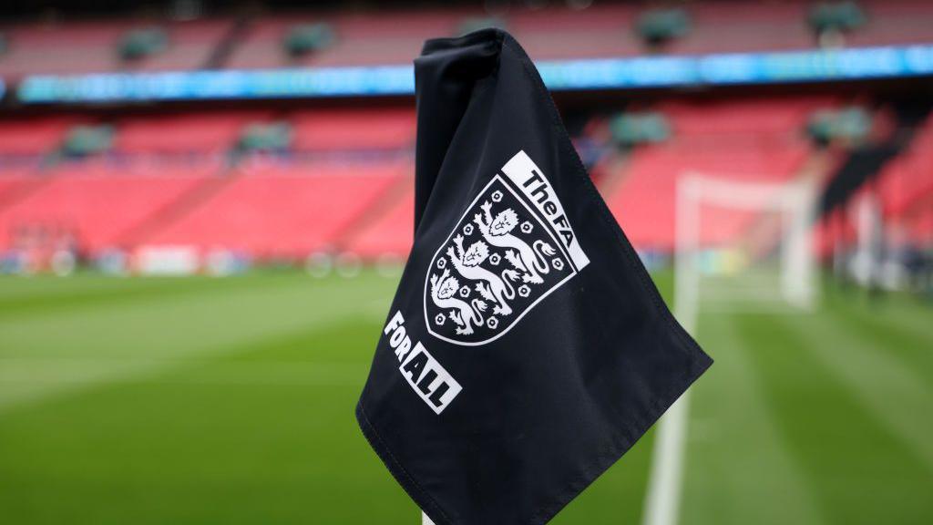 Soccer players on the field, reflecting current debates in football regulations