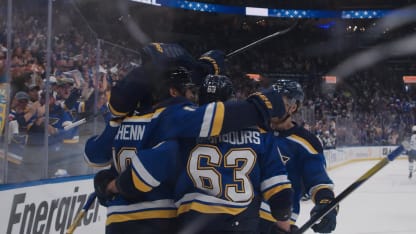 Jake Neighbours battles for the puck during Blues hockey playoff action