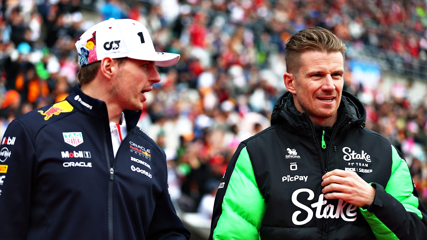 Kelly Piquet smiles while supporting Max Verstappen at an F1 grand prix.