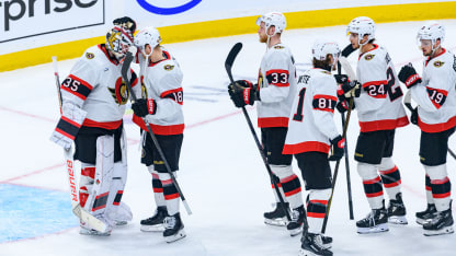 Maple Leafs vs Senators playoff action, players face off in a tense on-ice moment