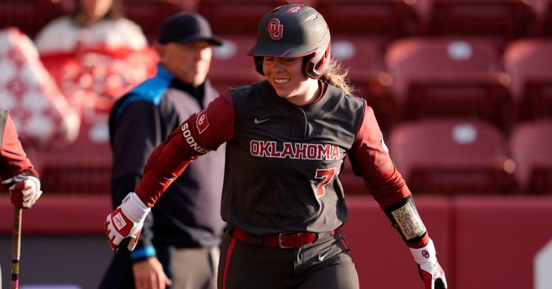 Fans fill the stadium, creating an energetic atmosphere during an SEC softball matchup.