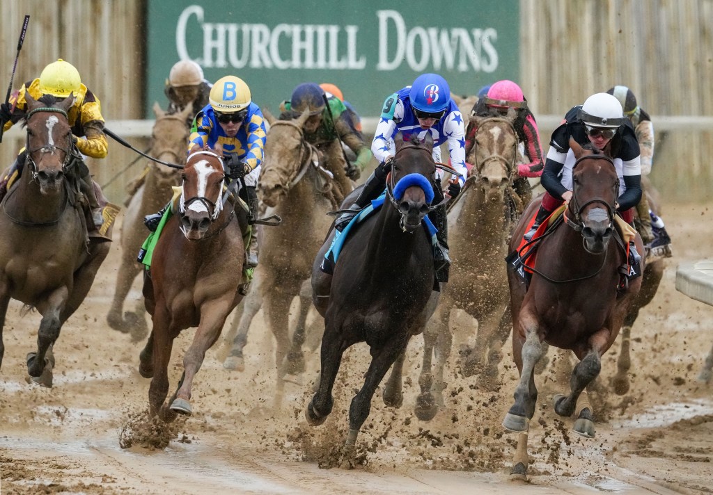 Livvy Dunne at Kentucky Oaks in a pink dress, giving 'Riders Up' command