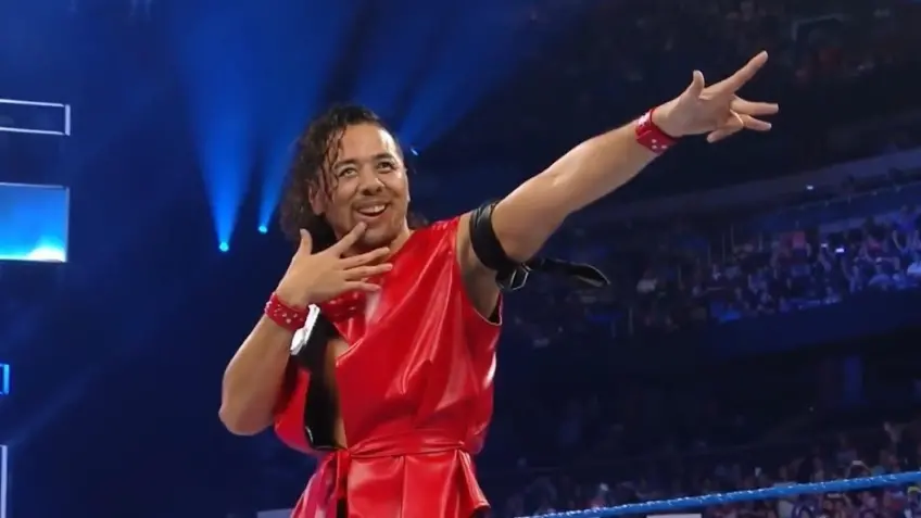 Shinsuke Nakamura poses during a WWE entrance, embodying his iconic style.