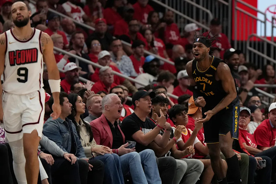 Excited fans and vibrant court atmosphere during Houston Rockets vs Golden State Warriors playoff game