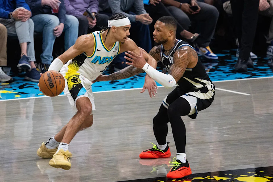 Andrew Nembhard driving past defenders during the NBA Playoffs