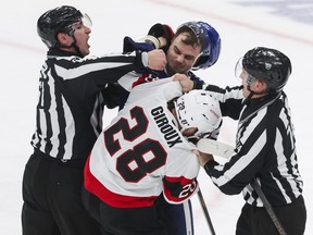 Chris Tanev celebrates with teammates during an NHL game