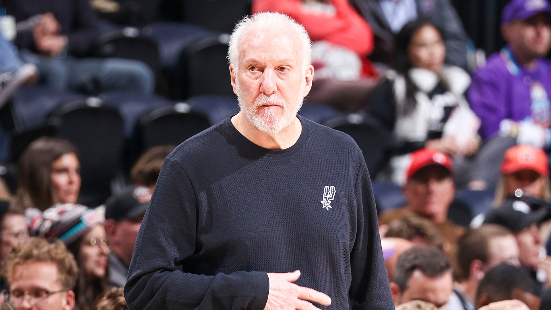 Mitch Johnson shakes hands with Gregg Popovich at the press event announcing the head coach change.