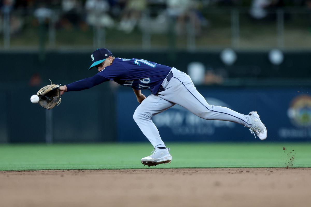 Seattle Mariners score action - team celebrates at home plate