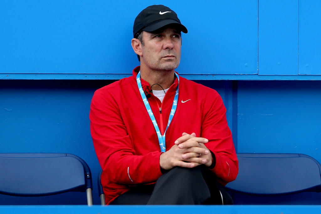 Iga Swiatek on court during a 2025 match, focusing before a serve