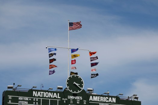 Robbie Ray pitching during Giants vs. Cubs with intense focus and wind-blown clouds in the backdrop.