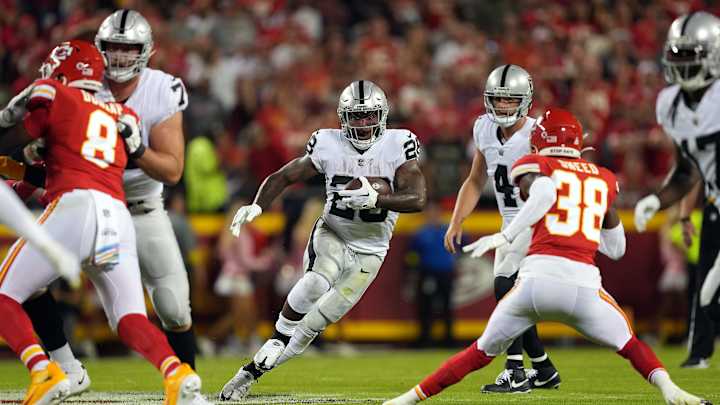 Josh Jacobs in NFL action, showcasing running back skills