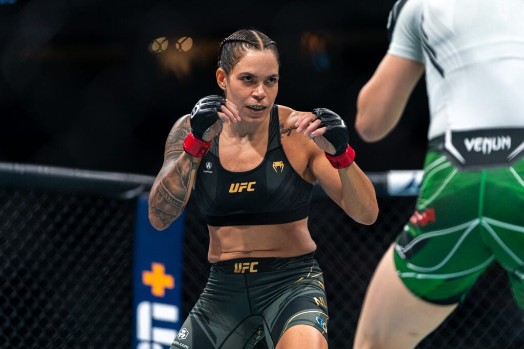 Amanda Nunes celebrates her UFC victory, symbolizing her unmatched legacy in women's MMA.