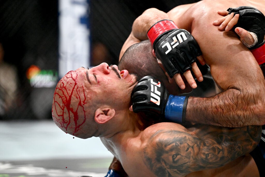 Aiemann Zahabi battling in the UFC Octagon, demonstrating skill and composure