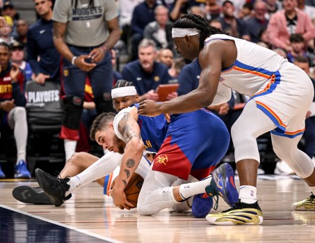 Shai Gilgeous-Alexander drives to the basket against the Denver Nuggets in the 2025 NBA Playoffs, highlighting his impressive stats and impact