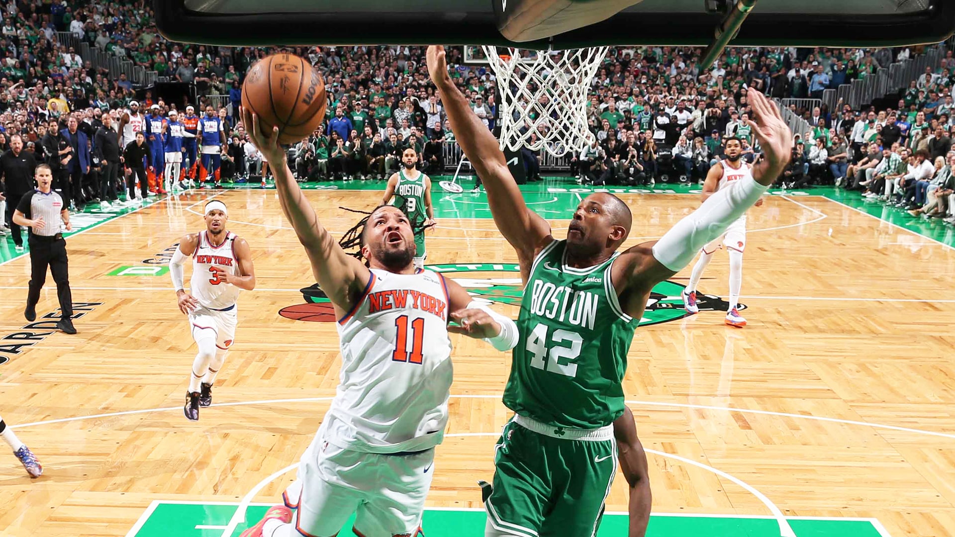 Celtics and Knicks players battle for a rebound during the 2025 NBA Playoffs Game 4