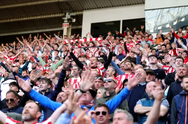 Sunderland vs Coventry players battling for possession in front of passionate fans at the Stadium of Light.