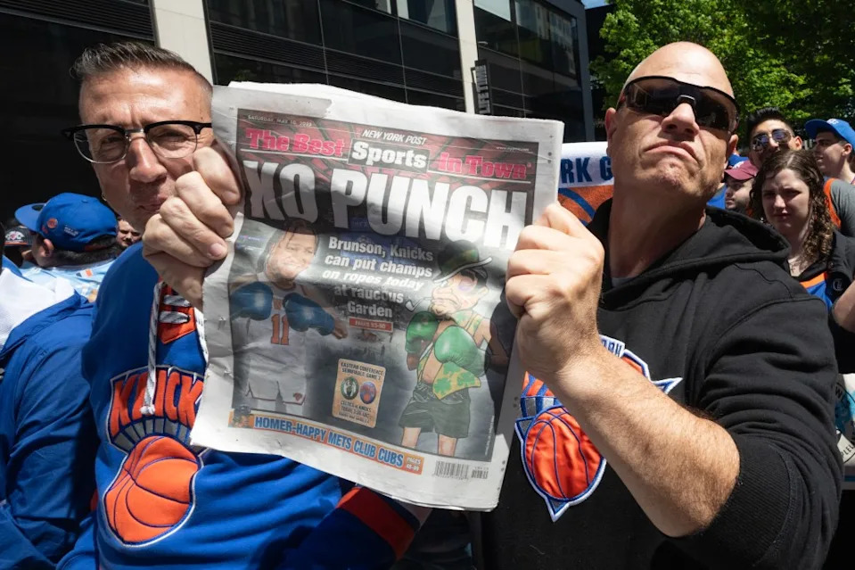 Excited Knicks fans with knicks tickets outside Madison Square Garden