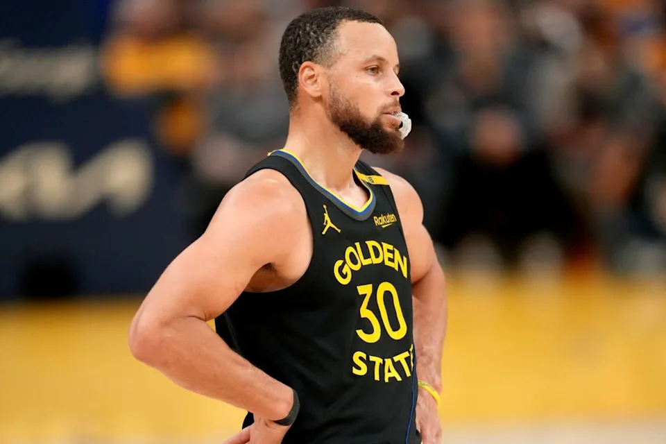 Steph Curry waiting on the sidelines during the playoffs.
