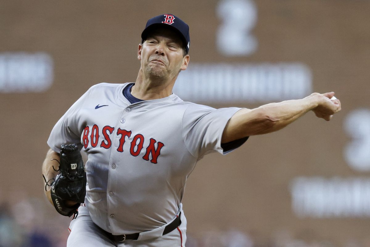 Rich Hill prepares to pitch during a minor league outing, showing focus and experience.