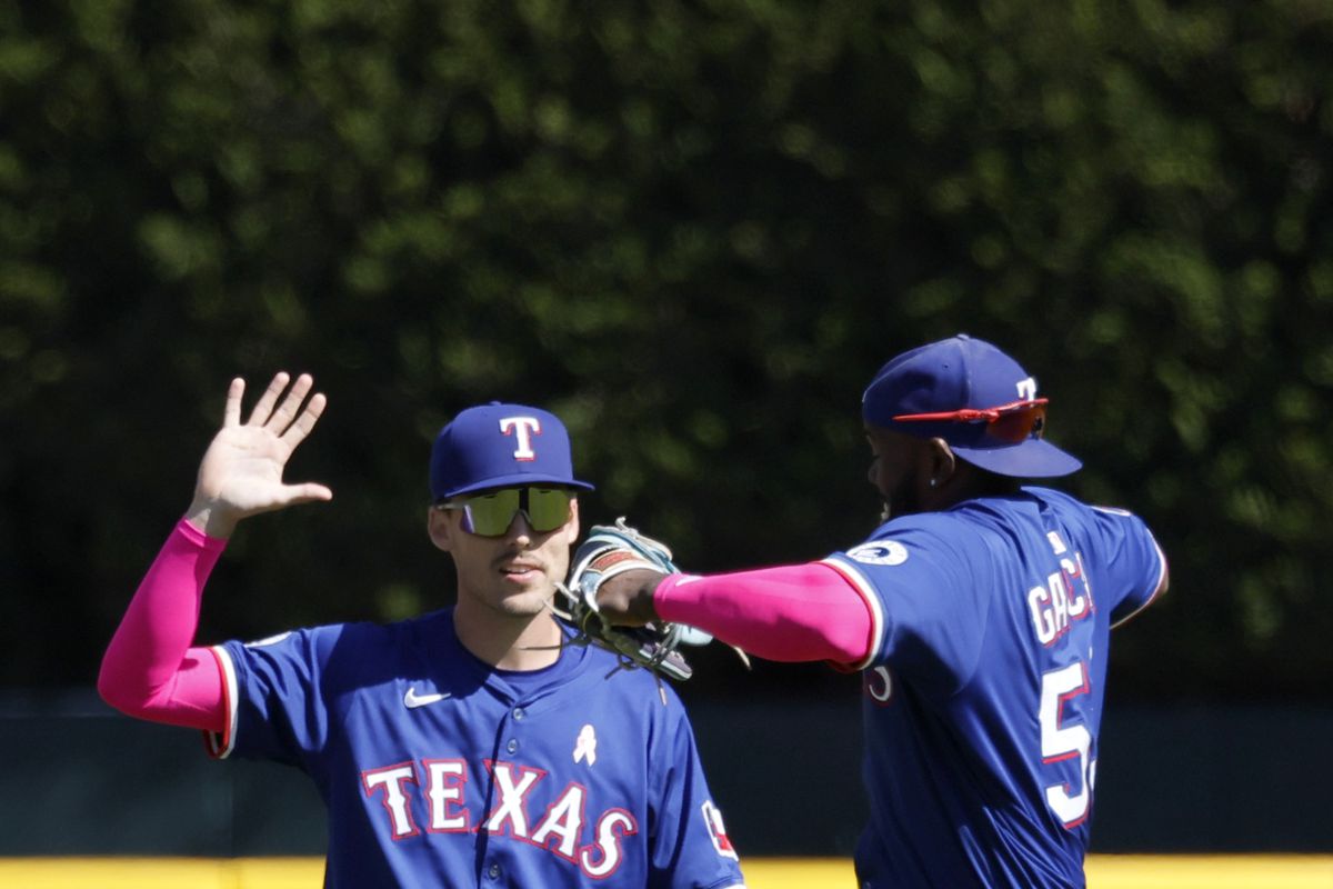 Rangers player in action against the Rockies