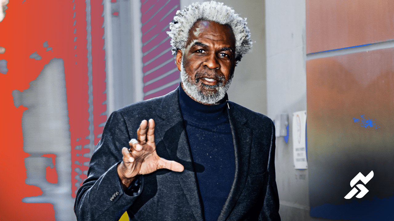 Charles Oakley courtside during a New York Knicks game, symbolizing his enduring presence in the basketball world