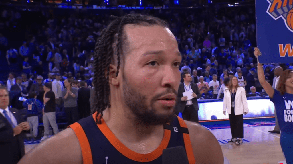 Jalen Brunson and wife Ali Marks posing at a Knicks event.