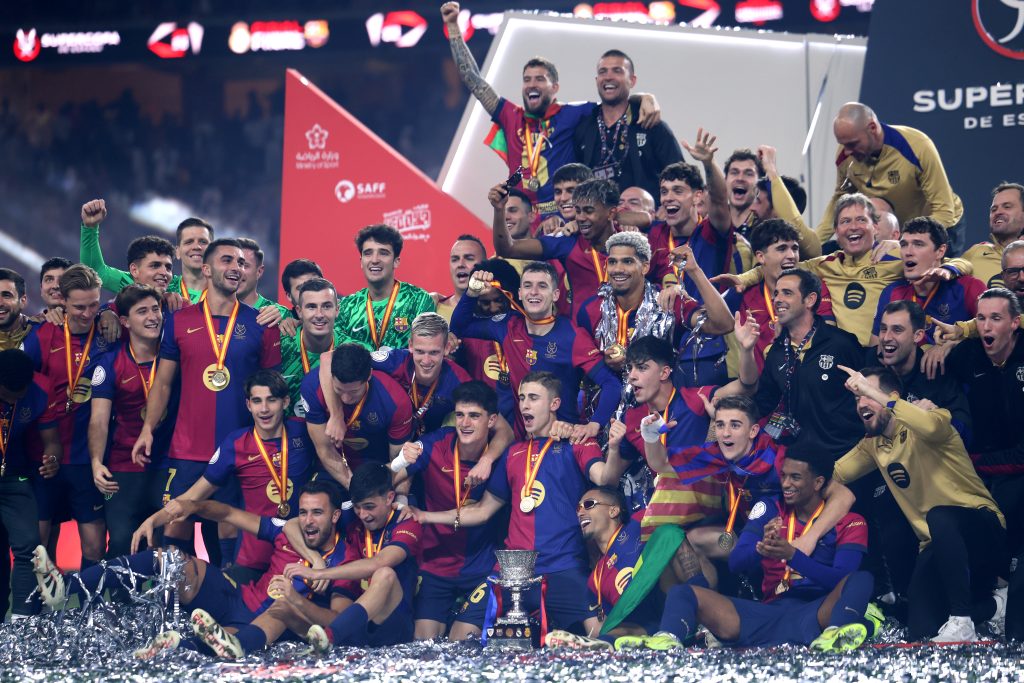Barcelona players celebrating after crucial victory. La Liga standings celebration.