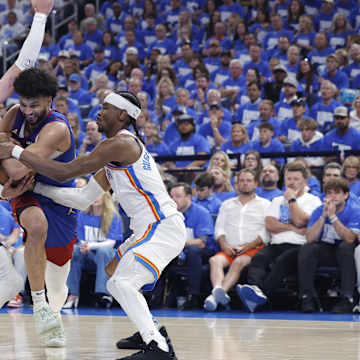 Nikola Jokic in action during an NBA Playoff game, showcasing impressive stats and influence on court.