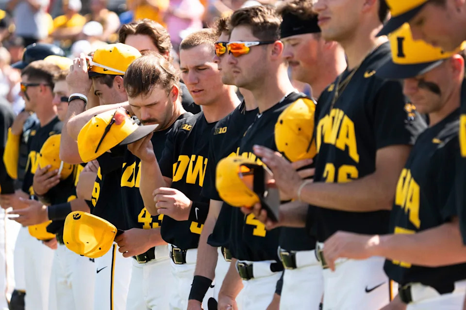 Iowa baseball players line up on the field before a crucial series