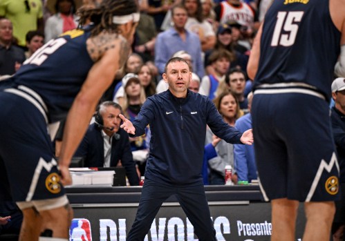 Rick Adelman courtside during an NBA game