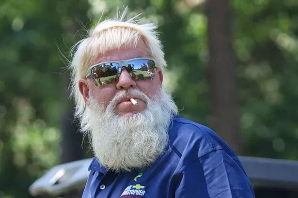 John Daly in action during a tournament, wearing his signature attire