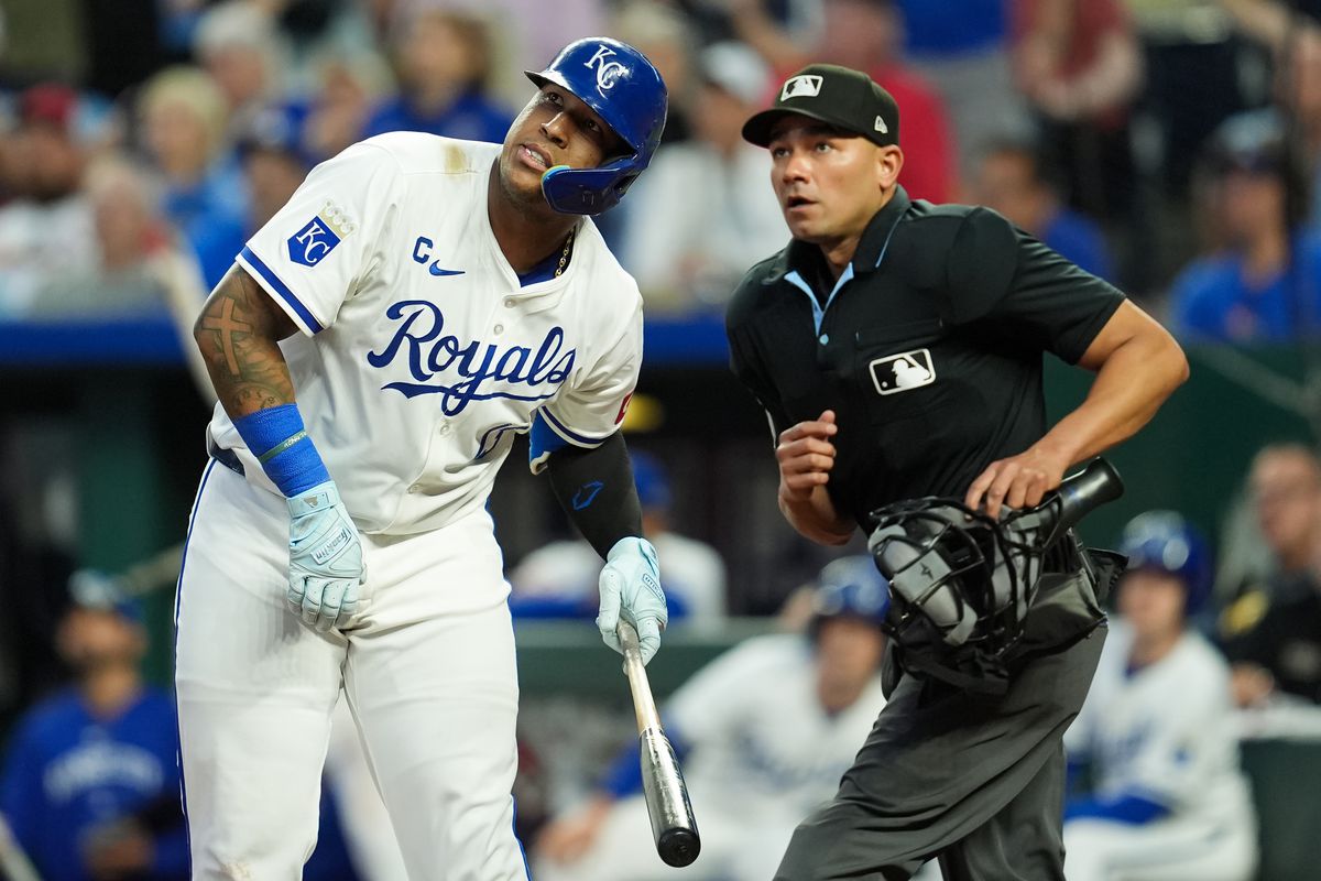 Coaches meeting before a key Cardinals vs Royals matchup in Kansas City