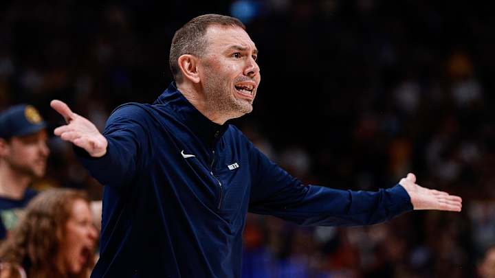 Rick Adelman courtside during an NBA game
