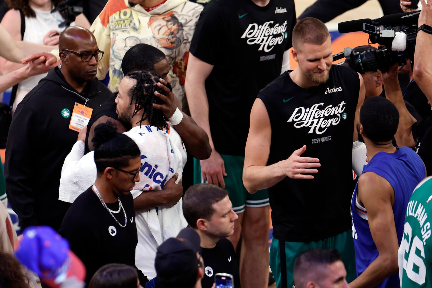 Celtics players walk off the court after a disappointing Celtics game against the Knicks. Boston fans process a tough playoff loss. Boston Celtics players leaving the court after a playoff defeat