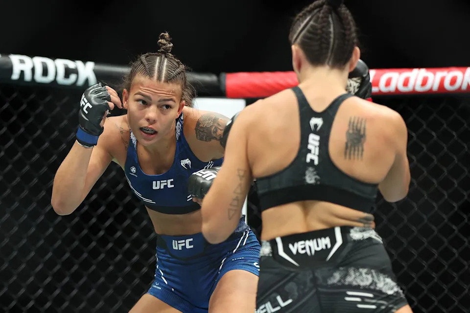 Luana Santos celebrates a victorious moment inside the UFC cage
