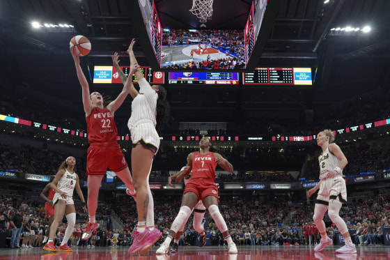 Diana Taurasi dribbles during a WNBA game, showcasing leadership and skills
