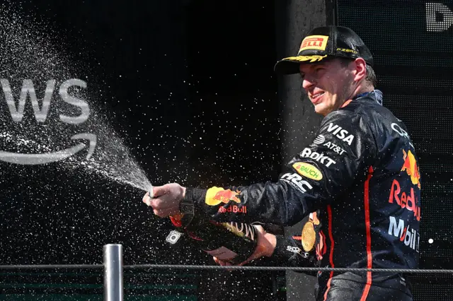 Max Verstappen crosses the finish line at Imola, exemplifying this season's intense F1 race time action
