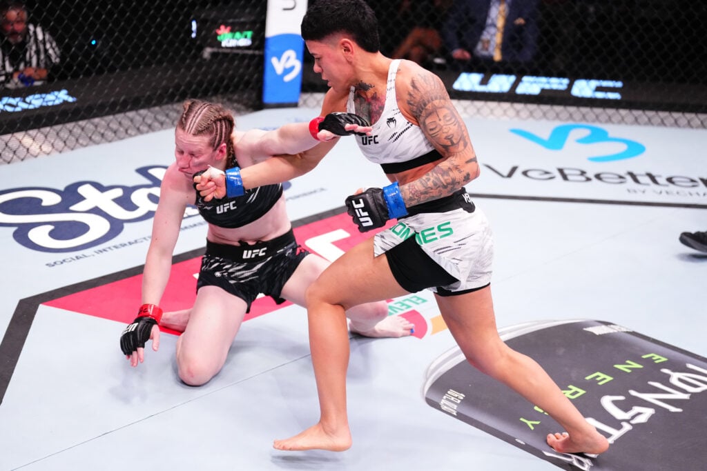 Denise Gomes lands a punch in her UFC fight