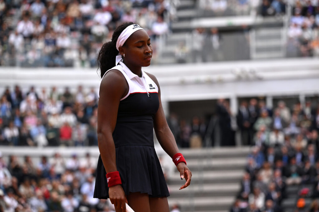 A packed Roland Garros stadium with fans cheering during a French Open match